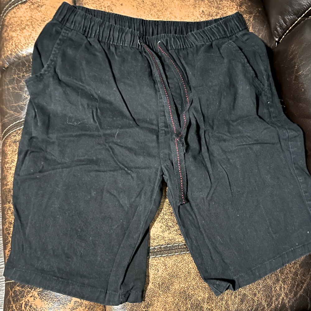 Black flat front Galaxy shorts.